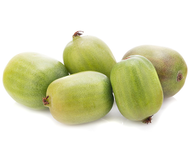 five hardy kiwi with green skin and a white background