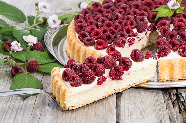 'Royalty' Raspberries on top of a cheesecake on a silver platter