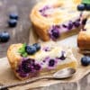 A slice of a Patriot blueberry tart on parchment paper with spoon.